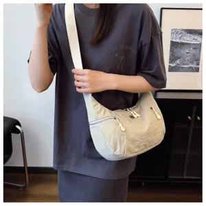Casual nylon crossbody shoulder bag for women, lightweight crescent dumpling bag style.