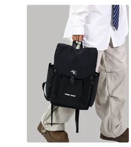 Detailed view of the stylish black casual backpack with front flap, showcasing large capacity.