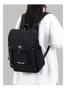 Details of the casual black backpack showing durable fabric, flap closure and spacious back fit.