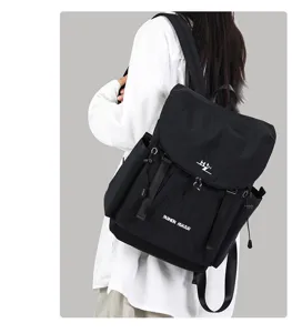 Detail view of the black canvas backpack, featuring large capacity and stylish casual design.