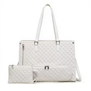 White quilted tote bag detail showing diamond pattern texture, dual handles and zipper pocket.