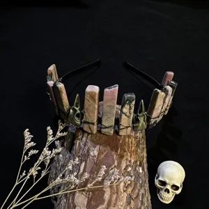 Close-up detail shot of gothic crystal crown headband with raw stones and skull charms.