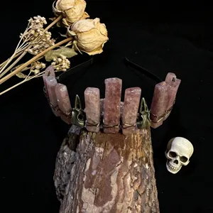 Gothic crystal crown headband with raw pink quartz pillars and raven skull charms detail.