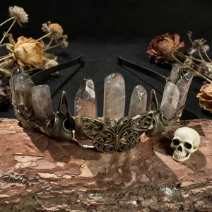 Close-up detail of gothic crystal crown headband with raw quartz and bronze butterfly decor.