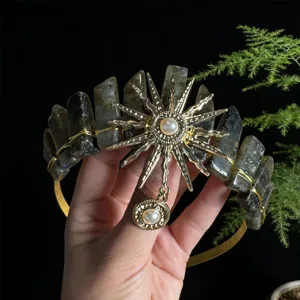 Detailed shot of the crystal tiara showcasing the intricate sun goddess metalwork and pearls.