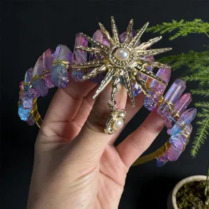 Detail view of crystal crown headband with gold sunburst charm and aura quartz clusters.
