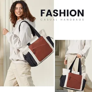 Vista detallada del bolso shopper acolchado colorblock con bolsillo frontal con cierre.