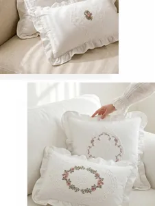 Detailed shot of French vintage white throw pillow with delicate lace embroidery and ruffles.