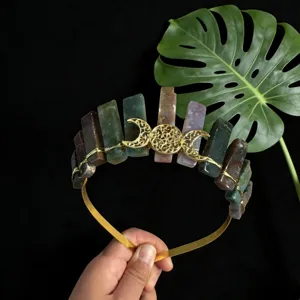 Gros plan du serre-tête couronne en cristal naturel avec triple lune dorée et pierres brutes.