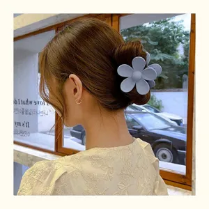 Matte blue flower hair claw clip for women, stylish cute shark clip for thick hair updo styles.