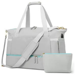 Close-up details of the grey travel duffel bag featuring a convenient USB port and shoe zone.