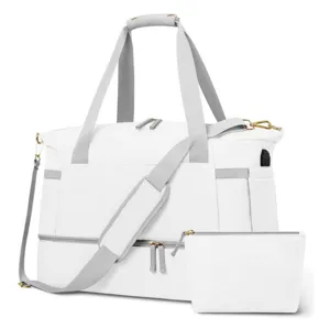 White travel duffel bag with USB charging port, gray straps, and matching pouch detail.