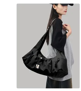 Detailed view of the black hobo shoulder bag highlighting strap design and large capacity.