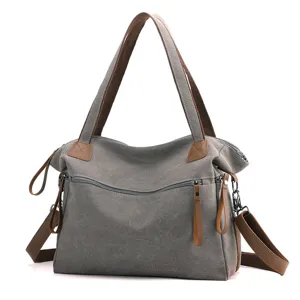 Casual grey canvas tote shoulder bag with brown straps, stylish large capacity design.