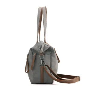 Grey canvas tote bag with brown leather handles, large capacity shoulder crossbody bag.