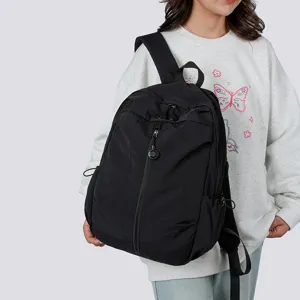 Unisex lightweight black backpack casual travel school bookbag with front zipper pocket.