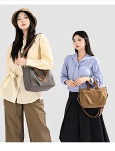 Canvas shoulder bag detail showcasing large capacity, dual color options and durable fabric.