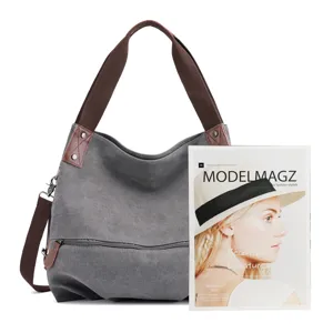 Classic grey canvas shoulder bag for women with brown straps and spacious hobo design.