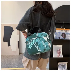 2025 new trendy graffiti canvas shoulder bag, cute large capacity crossbody tote for students.
