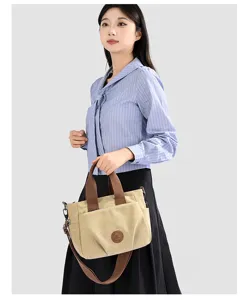 Stylish casual canvas shoulder bag for women, versatile daily crossbody tote with brown handles.