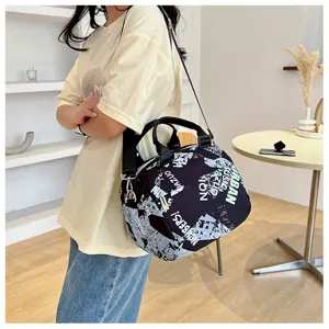 Trendy canvas shoulder bag for women with graffiti print, large capacity casual crossbody tote.
