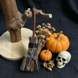 Miniature Halloween witch broom with gothic cross pendant and mini pumpkins decor.