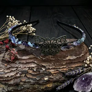Crystal chip headband detail showing intricate butterfly charm and natural purple stones.