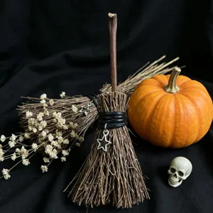 Miniature witch broom Halloween decoration with star charm, rustic handmade festival party prop.