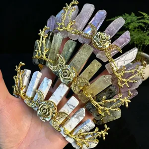 Detailed view of handmade crystal crown featuring natural stone pillars, gold branches, and moon motifs.