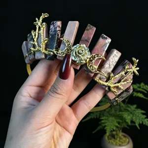 Detailed view of handmade crystal tiara with golden branches, crescent moons, and rose decor.