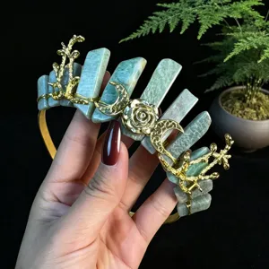 Detailed view of gold crystal crown headband with green pillars, rose and moon charms for women
