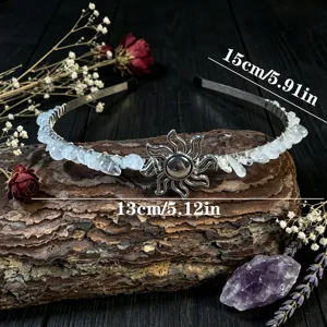 Detail shot of crystal chipped headband with sun charm on rustic wood background.