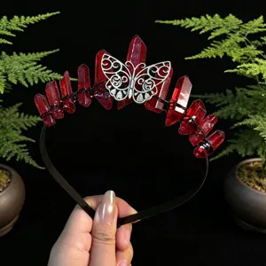 Close-up detail of the handmade red crystal crown headband with silver butterfly ornament.