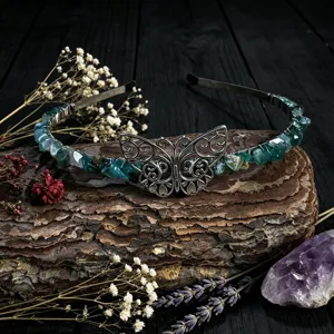 Close-up detail of the handmade green crystal chip headband featuring an exquisite metal butterfly.