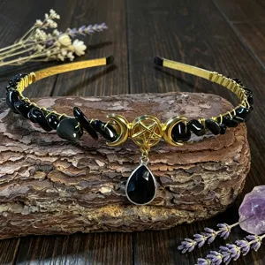 Close-up detail shot of the handmade crystal crescent moon and pentagram hair accessory.