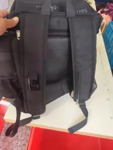 Black backpack detail view showing breathable mesh back panel, adjustable straps and durable fabric.