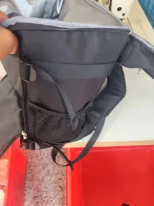 Black insulated cooler backpack with dual leak-proof compartments and mesh side pockets.