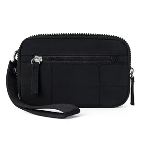 Close-up detail of black quilted nylon mini wallet with wrist strap and zipper pocket.
