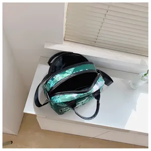 Green graffiti canvas shoulder bag for women, stylish large capacity crossbody tote bag.