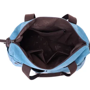 Casual blue canvas tote bag for women with brown handles and multi-pocket interior design.