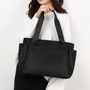 Black nylon tote bag, casual multi-pocket travel shoulder bag with large capacity for women.
