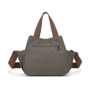 Vintage washed canvas messenger bag with extended straps for men and women school commute use.