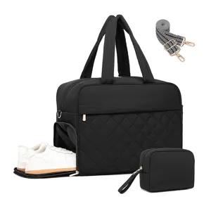 Black quilted travel duffel bag with separate shoe compartment and matching pouch detail.