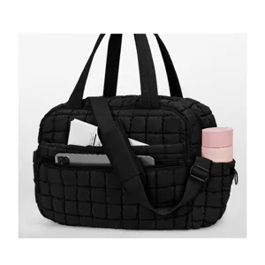 Black quilted travel duffle bag tote shoulder bag with top handles and adjustable strap.