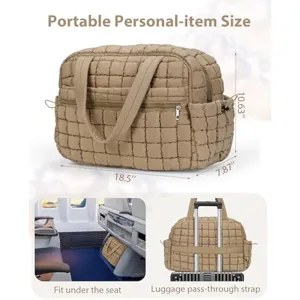 Puffy quilted travel tote bag personal item size with luggage strap under seat design.