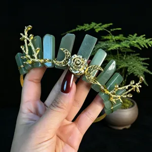 Detailed view of the green crystal goddess tiara crown featuring moon and branch.