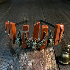 Detailaufnahme des gotischen Kristalldiadems mit roten Steinpfeilern und Metallbiene.