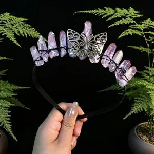 Detailed close-up of pink aura quartz crystal tiara with butterfly motif and black headband.