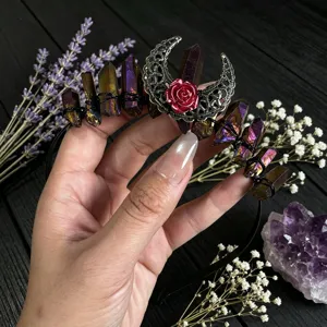 Close-up of gothic crystal headband featuring aura quartz, filigree moon and red rose.