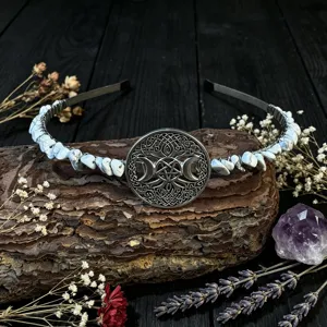 Detailed close-up showing the intricate metal triple moon pentagram pendant and white crystal chips.